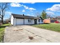 Front view of a remodeled ranch home with a long driveway at 1904 Schwier Dr, Indianapolis, IN 46229