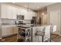Modern kitchen featuring white cabinets, granite countertops, and stainless steel appliances at 19629 Astoria Ave, Sheridan, IN 46069