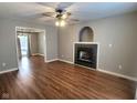 Living room with hardwood floors, fireplace, and ceiling fan at 2062 Sumpter Trl, Columbus, IN 47203