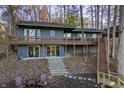 Lakefront home with wrap-around deck and stairs leading to the water at 387 W Roszell Dr, Nineveh, IN 46164