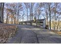 Gray lake house nestled among trees with a long private driveway at 387 W Roszell Dr, Nineveh, IN 46164