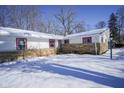 Front view of a ranch house with snowy yard and stone exterior at 4201 Westbourne Dr, Indianapolis, IN 46205