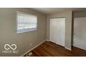 A bedroom featuring hardwood floors, window, and closet space at 529 S Kiel Ave, Indianapolis, IN 46241