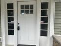 Charming white front door with six-light transom window at 555 N Oakland Ave, Indianapolis, IN 46201