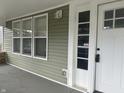 Inviting front porch with updated siding and white door at 555 N Oakland Ave, Indianapolis, IN 46201