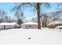 Front of house view, snow covered yard at 555 N Sadlier Dr, Indianapolis, IN 46219