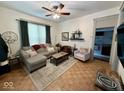 Bright living room featuring hardwood floors, a ceiling fan, and cozy seating arrangement at 630 E Mccarty St, Indianapolis, IN 46203