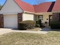 Well-kept single story home with lush landscaping, charming curb appeal, and attached garage at 6425 Peace Pl, Indianapolis, IN 46268