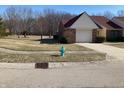 Residential street view featuring a well-manicured lawn, blue fire hydrant, and neatly maintained homes at 6425 Peace Pl, Indianapolis, IN 46268