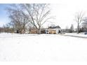 Brick ranch home with attached garage, snow on the ground at 7201 E 71St St, Indianapolis, IN 46256