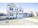 Two-story home with gray siding, white accents, and a two-car garage at 8870 Walker St, Fortville, IN 46040