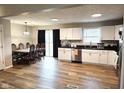 Bright and spacious kitchen and dining area with white cabinetry and wood flooring at 9812 W 900 N Rd, Elwood, IN 46036