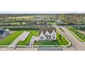 Breathtaking aerial view of a new construction home with an expansive lawn, green space, and landscaping at 11430 Aubrey Ln, Fishers, IN 46040