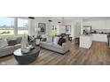 Open-concept living space with a combined living room, dining area, and kitchen at 11614 Hartwell St, Indianapolis, IN 46235