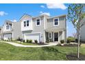 Charming two-story home with a manicured lawn, inviting entrance, and a two-car garage at 11626 Hartwell St, Indianapolis, IN 46235