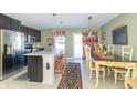 Spacious kitchen with stainless steel appliances, an island, and a dining area at 1226 Arlington Dr, Greenfield, IN 46140