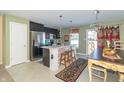 Eat-in kitchen with stainless steel appliances and an island with brick detailing at 1226 Arlington Dr, Greenfield, IN 46140
