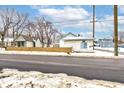 Small house with a wooden fence and snow on the ground at 1363 & 1367 S Belmont Ave, Indianapolis, IN 46221