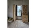 Image of a room under renovation, featuring new drywall, wooden planks, and natural light through the window at 1601 Spann Ave, Indianapolis, IN 46203