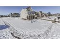 Snow-covered yard with a two-story house and neighborhood view at 1630 Lavender Ln, Greenwood, IN 46143