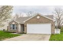 Charming single Gathering home with brick and siding, attached garage and freshly mulched landscaping at 1681 Copeland Farms Dr, Greenfield, IN 46140
