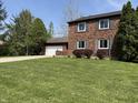 Charming brick home with a well-manicured lawn and attached garage, great curb appeal at 30 Village Ct, Zionsville, IN 46077