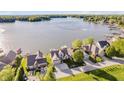 Stunning aerial view of waterfront homes, showcasing lake access and beautiful landscaping at 3150 Beach Blvd, Cicero, IN 46034