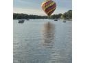 Hot air balloon over calm lake water with boats at 3150 Beach Blvd, Cicero, IN 46034