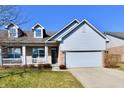 A welcoming single-Gathering home featuring a front porch, dormer windows, and attached garage at 316 Society Dr, Indianapolis, IN 46229