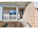 Inviting brick-clad front porch and entry featuring a storm door and space to relax at 316 Society Dr, Indianapolis, IN 46229