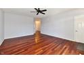 An empty living room featuring shiny hardwood floors, gray paint, and a ceiling fan at 316 Society Dr, Indianapolis, IN 46229