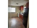 Kitchen features wood cabinets, white appliances, and tile floors at 3355 Wallace Ave, Indianapolis, IN 46218