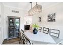 Bright dining room featuring a rustic table and modern chandelier at 3828 Highland Park Dr, Greenwood, IN 46143