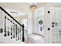 Elegant entryway with a grand staircase and stained-glass door at 3828 Highland Park Dr, Greenwood, IN 46143