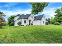 White brick home with a large front yard and mature trees at 3828 Highland Park Dr, Greenwood, IN 46143