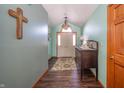 Bright entryway with wood floors, antique console table, and decorative cross at 5105 S Montego Way, Muncie, IN 47302