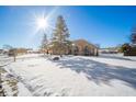 Ranch style brick home with snow covered yard and sunny day at 5105 S Montego Way, Muncie, IN 47302