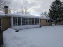 Sunroom and backyard covered in snow at 515 Wedgewood Dr, Anderson, IN 46013