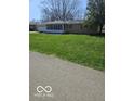 A well-maintained lawn surrounds a charming single-story home with a sunroom at 515 Wedgewood Dr, Anderson, IN 46013