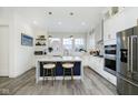 Modern white kitchen with marble island and stainless steel appliances at 559 Fulton St, Indianapolis, IN 46202