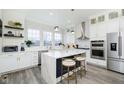 Modern white kitchen with marble island, stainless steel appliances at 559 Fulton St, Indianapolis, IN 46202