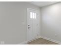 Simple white front door with glass panels in a light-colored room at 6322 Loraine Dr, Brownsburg, IN 46112