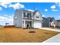 Gray two-story house with a white garage door and driveway at 6869 Orchard Run Cir, Whitestown, IN 46075