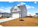 Side view of a two-story house with gray siding and a white garage door at 6869 Orchard Run Cir, Whitestown, IN 46075