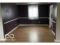 Bright dining room features hardwood floors and dark-painted walls at 810 Kendale Ct, Indianapolis, IN 46234