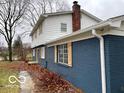 Side view of the house, highlighting its blue brick and white siding exterior at 810 Kendale Ct, Indianapolis, IN 46234