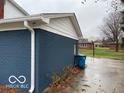 Rear exterior of the house, showcasing a dark blue brick wall and a spacious driveway at 810 Kendale Ct, Indianapolis, IN 46234