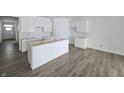 New kitchen with white cabinets and gray vinyl flooring at 8750 Walker St, Fortville, IN 46040