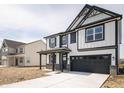 Two-story home with black and white facade, porch, and a two-car garage at 8798 Walker St, Fortville, IN 46040