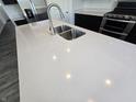 Quartz kitchen island with double sink and modern faucet at 8798 Walker St, Fortville, IN 46040